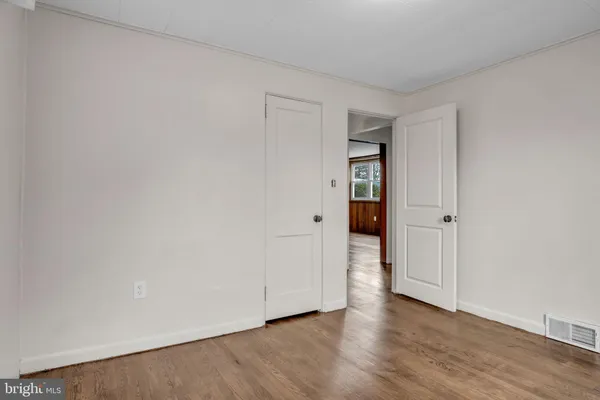 a view of an empty room and wooden floor