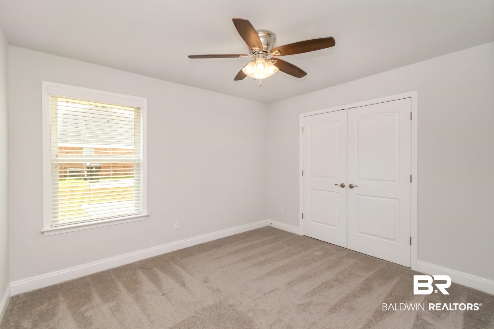 6632 Monarch Circle Mobile, AL 36618 - Photo 16 of 32 Unfurnished bedroom featuring light carpet, ceiling fan, and a closet