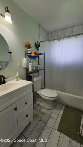 a bathroom with a sink mirror vanity and toilet