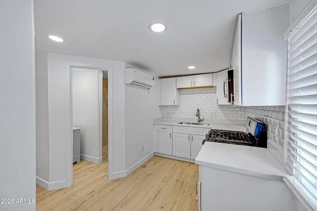a kitchen with a sink stove and microwave