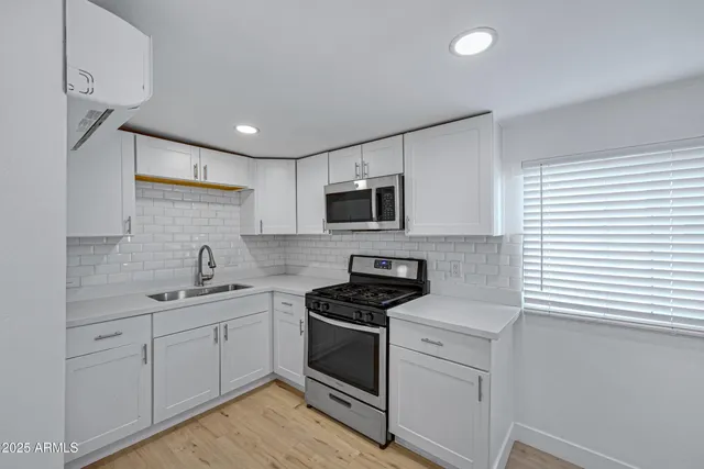 a view of a room with wooden floor and a window