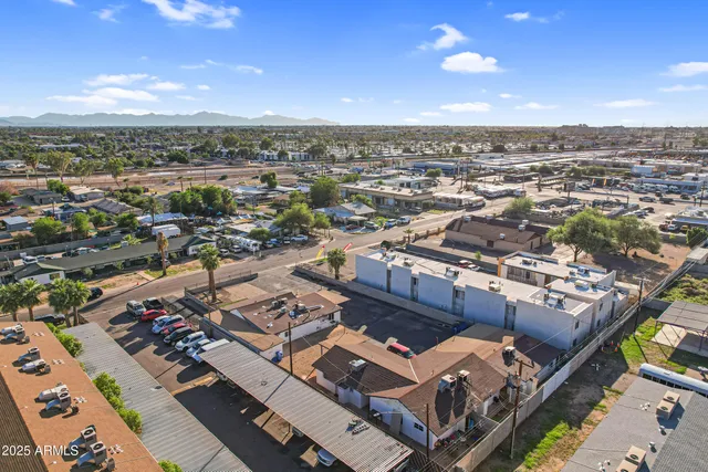 a view of a street with a cars parked on the road