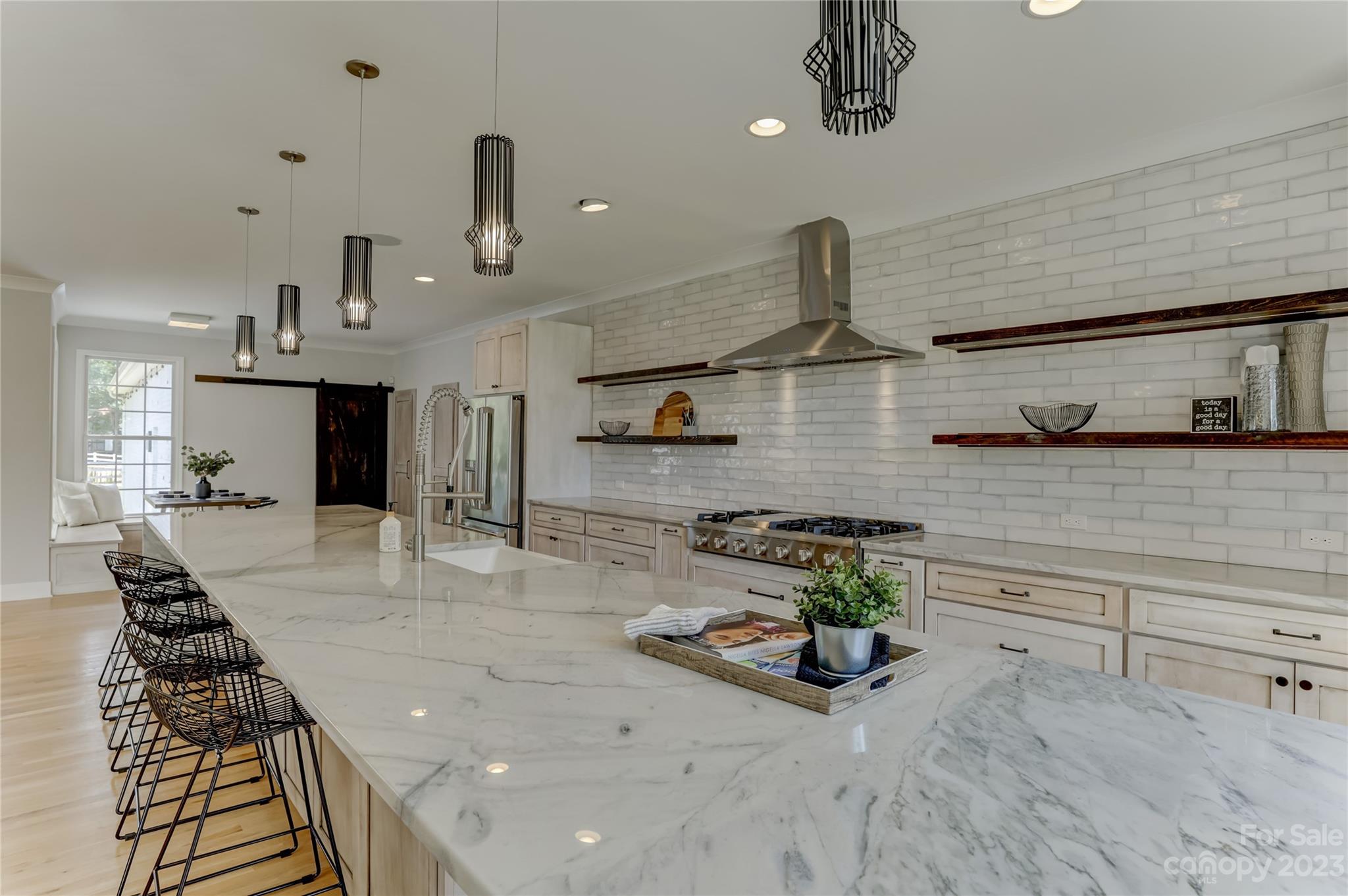 2354 Vineyard Road Fort Mill, SC 29708 - Photo 9 of 48 a kitchen with stainless steel appliances granite countertop a sink a stove and a wooden floors