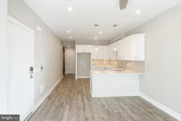 a view of a kitchen with a sink and a refrigerator
