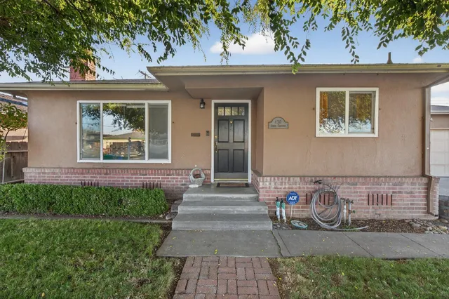 a front view of a house with garden