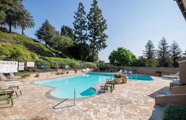 a view of a swimming pool with lounge chairs