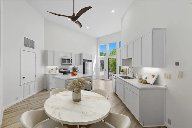 a living room with furniture and kitchen view