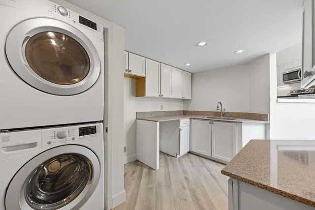 a kitchen with a refrigerator sink and cabinets