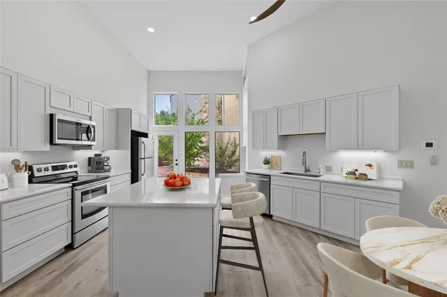 a kitchen with a sink stove top oven and cabinets