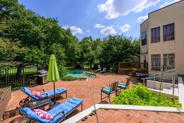 a view of a backyard with sitting area