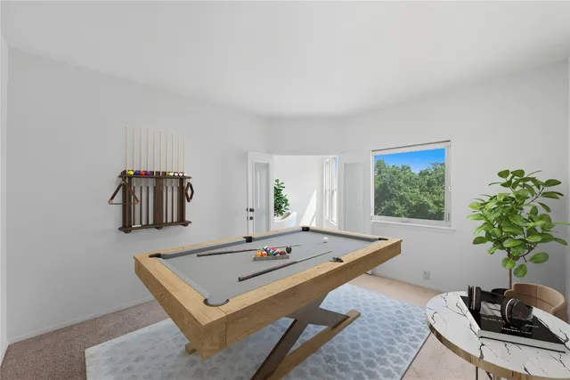 a living room with a couch and a potted plant