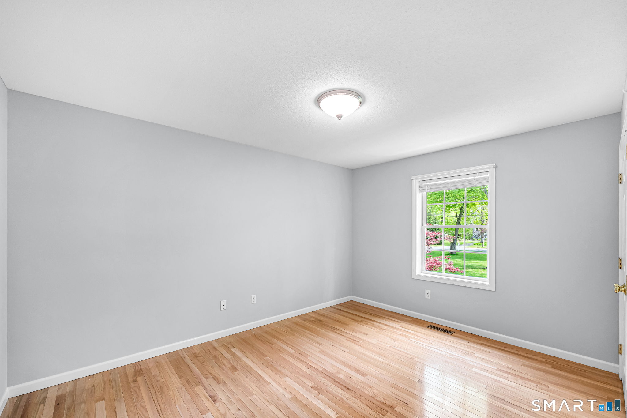 1001 Suffield Street Suffield, CT 06078 - Photo 14 of 30 a view of an empty room with wooden floor and a window