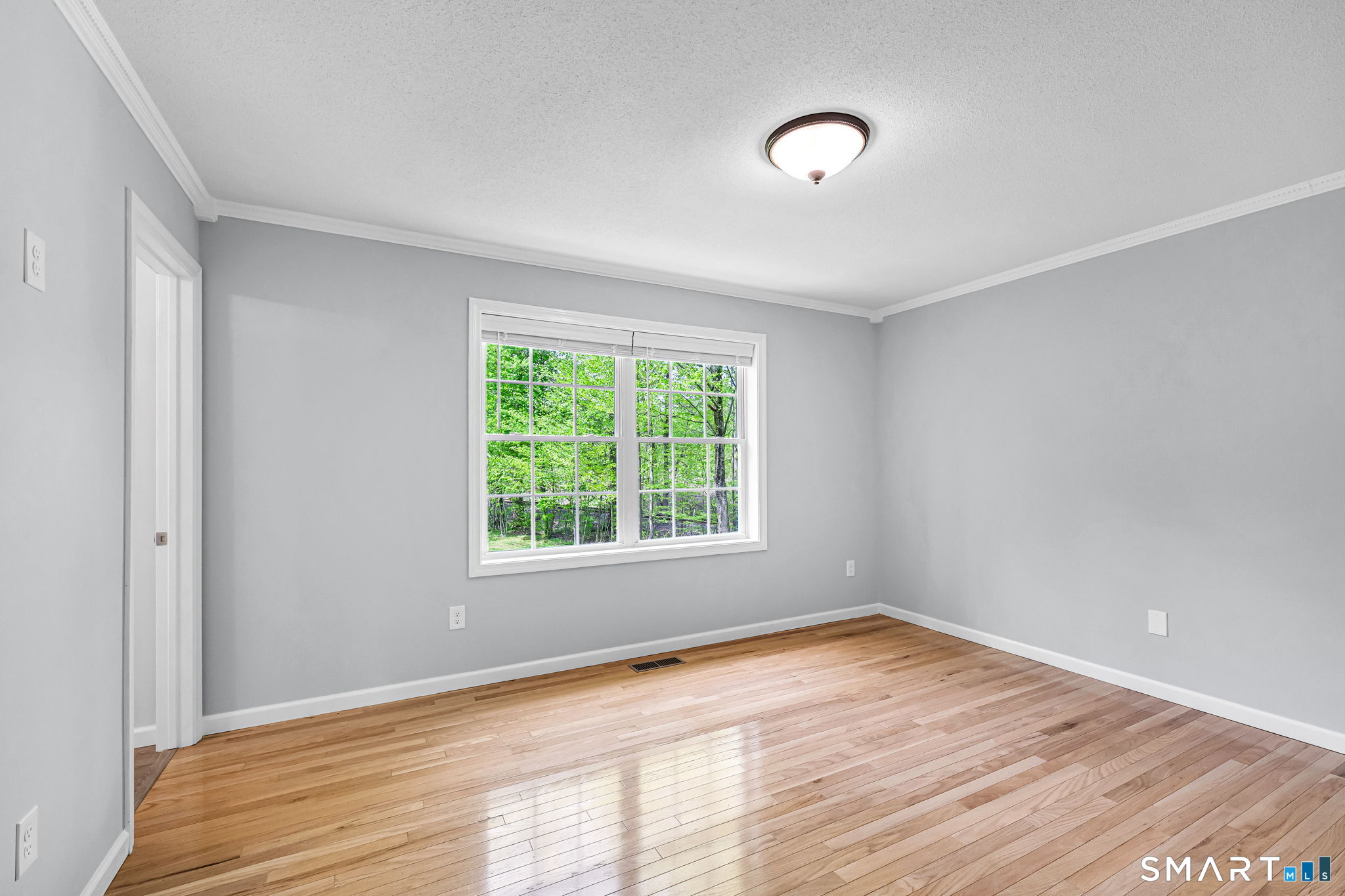 1001 Suffield Street Suffield, CT 06078 - Photo 16 of 30 a view of an empty room with wooden floor and a window