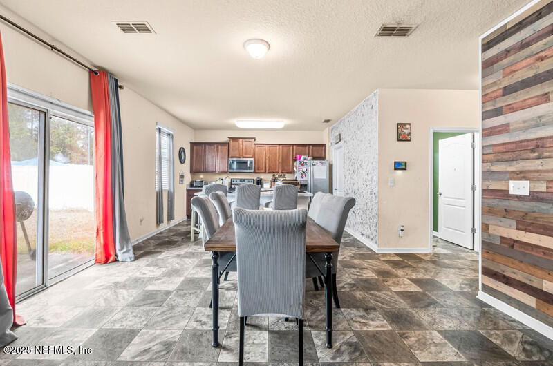 4076 Great Falls Loop Middleburg, FL 32068 - Photo 11 of 30 a view of a dining room with furniture