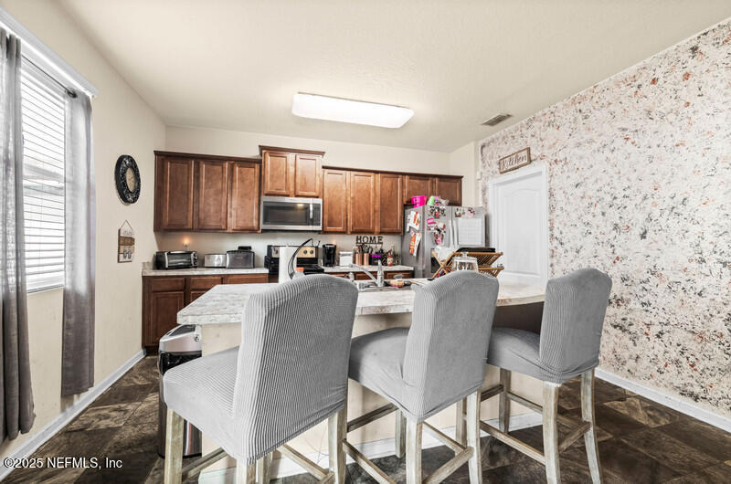 4076 Great Falls Loop Middleburg, FL 32068 - Photo 13 of 30 a dining room with furniture and a window