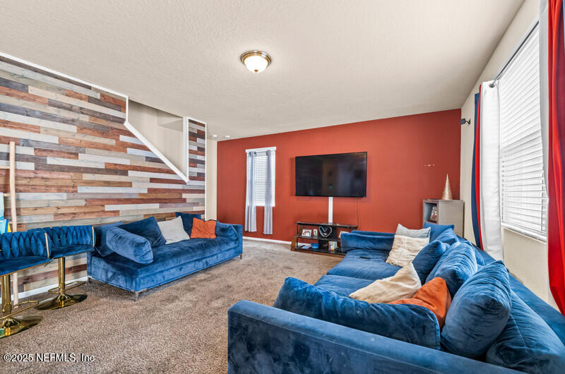 4076 Great Falls Loop Middleburg, FL 32068 - Photo 16 of 30 a living room with furniture and a flat screen tv