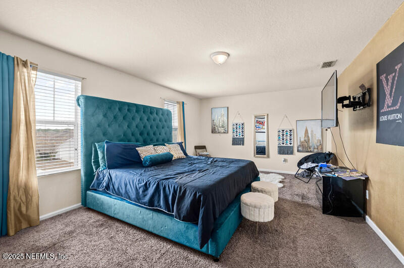 4076 Great Falls Loop Middleburg, FL 32068 - Photo 18 of 30 a bedroom with a bed and a couch