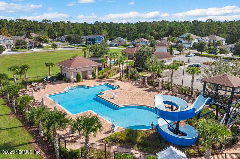 4076 Great Falls Loop Middleburg, FL 32068 - Photo 2 of 30 a view of a swimming pool with lawn chairs and a fire pit