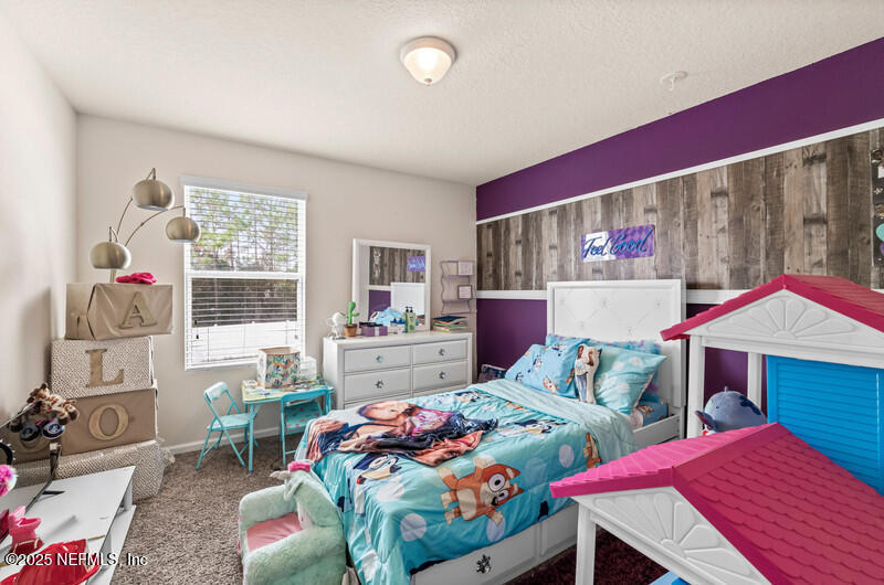 4076 Great Falls Loop Middleburg, FL 32068 - Photo 23 of 30 a bedroom with two beds and a dresser