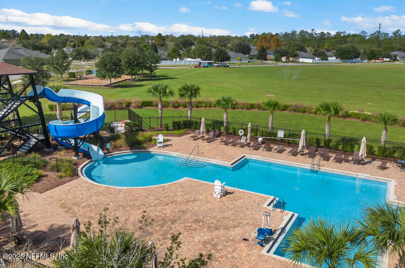 4076 Great Falls Loop Middleburg, FL 32068 - Photo 27 of 30 a view of a swimming pool with a patio and a garden