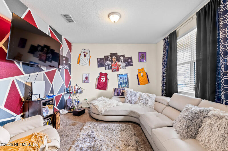 4076 Great Falls Loop Middleburg, FL 32068 - Photo 8 of 30 a bedroom with a bed and a couch