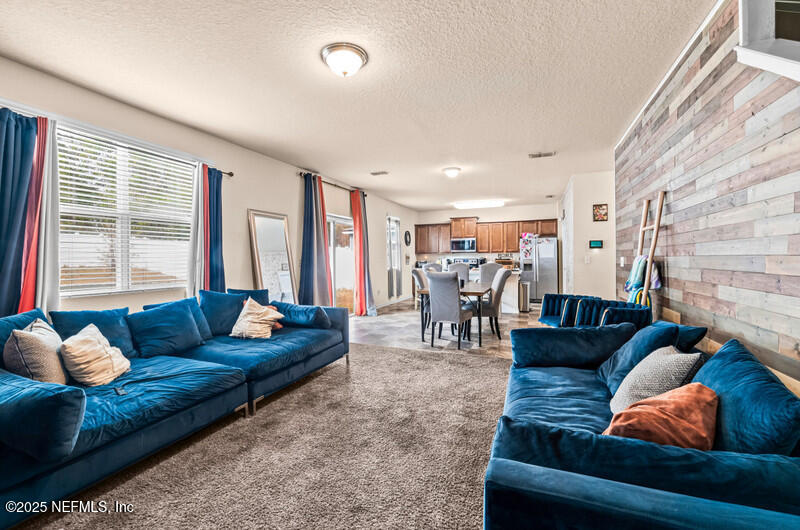 4076 Great Falls Loop Middleburg, FL 32068 - Photo 10 of 30 a living room with furniture and a large window