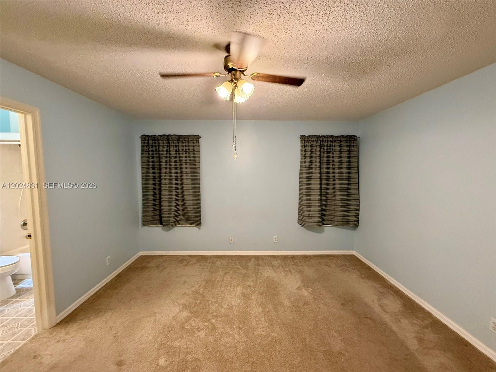 15819 76th Road North Loxahatchee, FL 33470 - Photo 34 of 45 an empty room with windows and fan