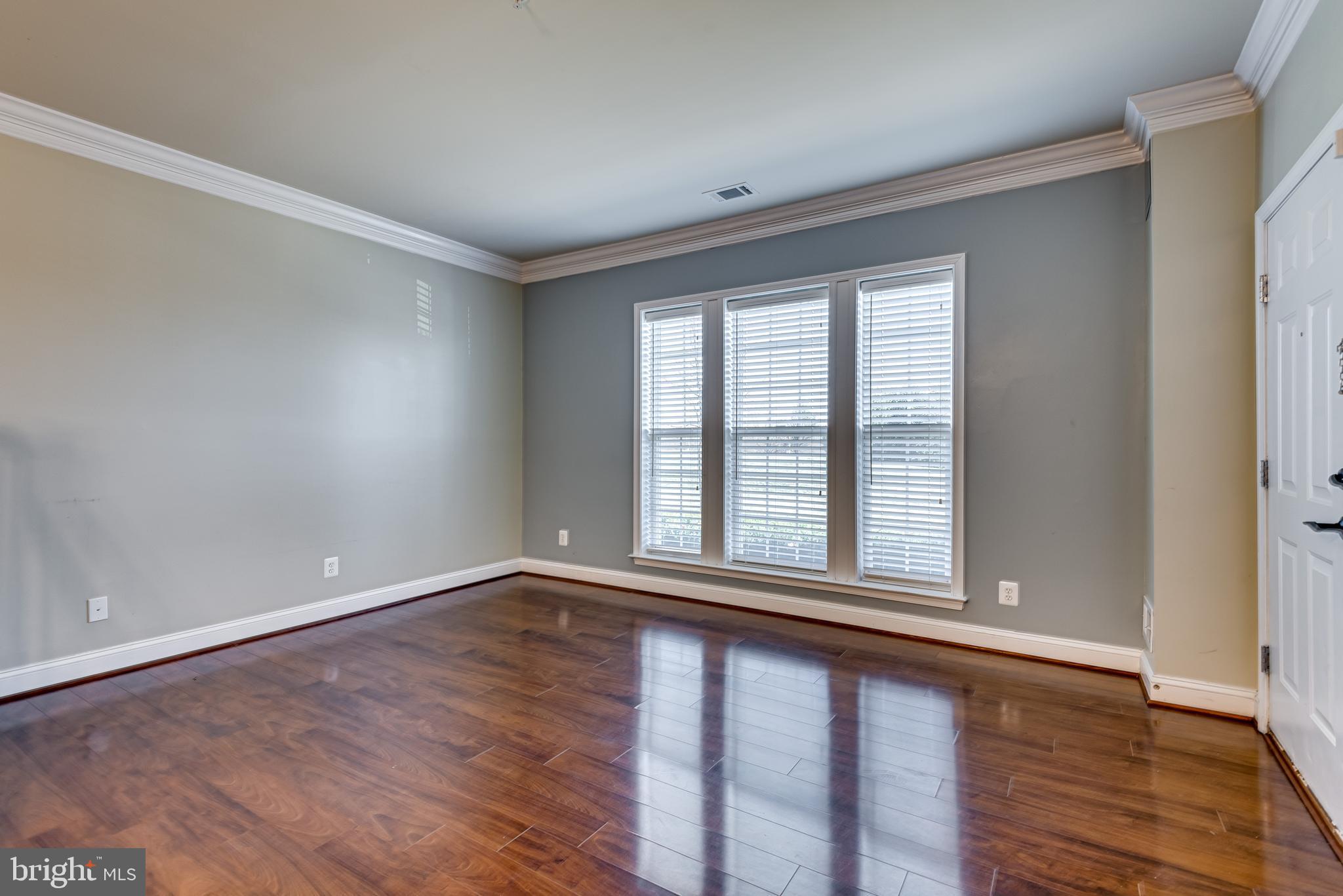 20654 Sibbald Square Ashburn, VA 20147 - Photo 11 of 43 a view of an empty room with wooden floor and a window