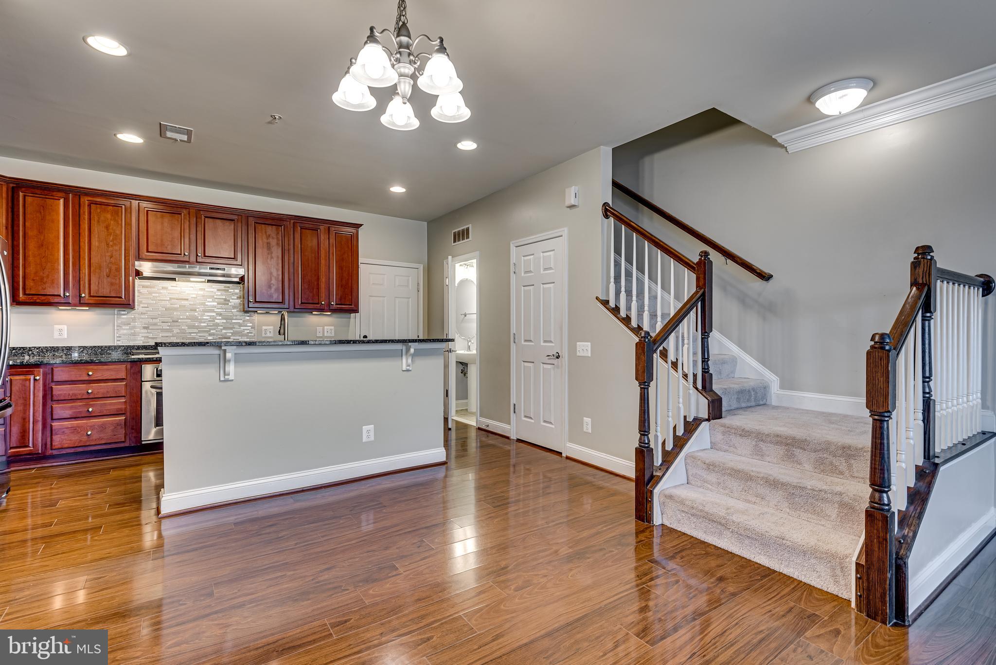 20654 Sibbald Square Ashburn, VA 20147 - Photo 12 of 43 a view of kitchen with granite countertop cabinets a sink and a wooden floor