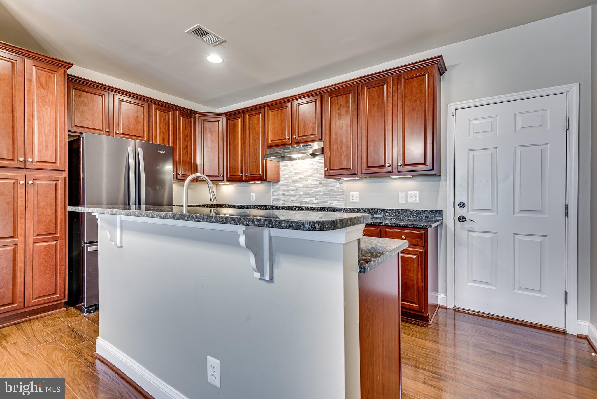 20654 Sibbald Square Ashburn, VA 20147 - Photo 14 of 43 a kitchen with stainless steel appliances granite countertop a refrigerator sink and cabinets