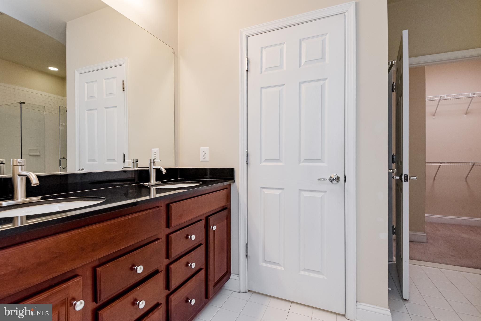 20654 Sibbald Square Ashburn, VA 20147 - Photo 27 of 43 a kitchen with stainless steel appliances a sink and cabinets
