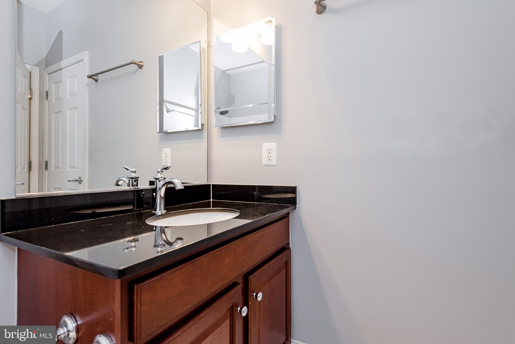 20654 Sibbald Square Ashburn, VA 20147 - Photo 34 of 43 a bathroom with a sink and a mirror