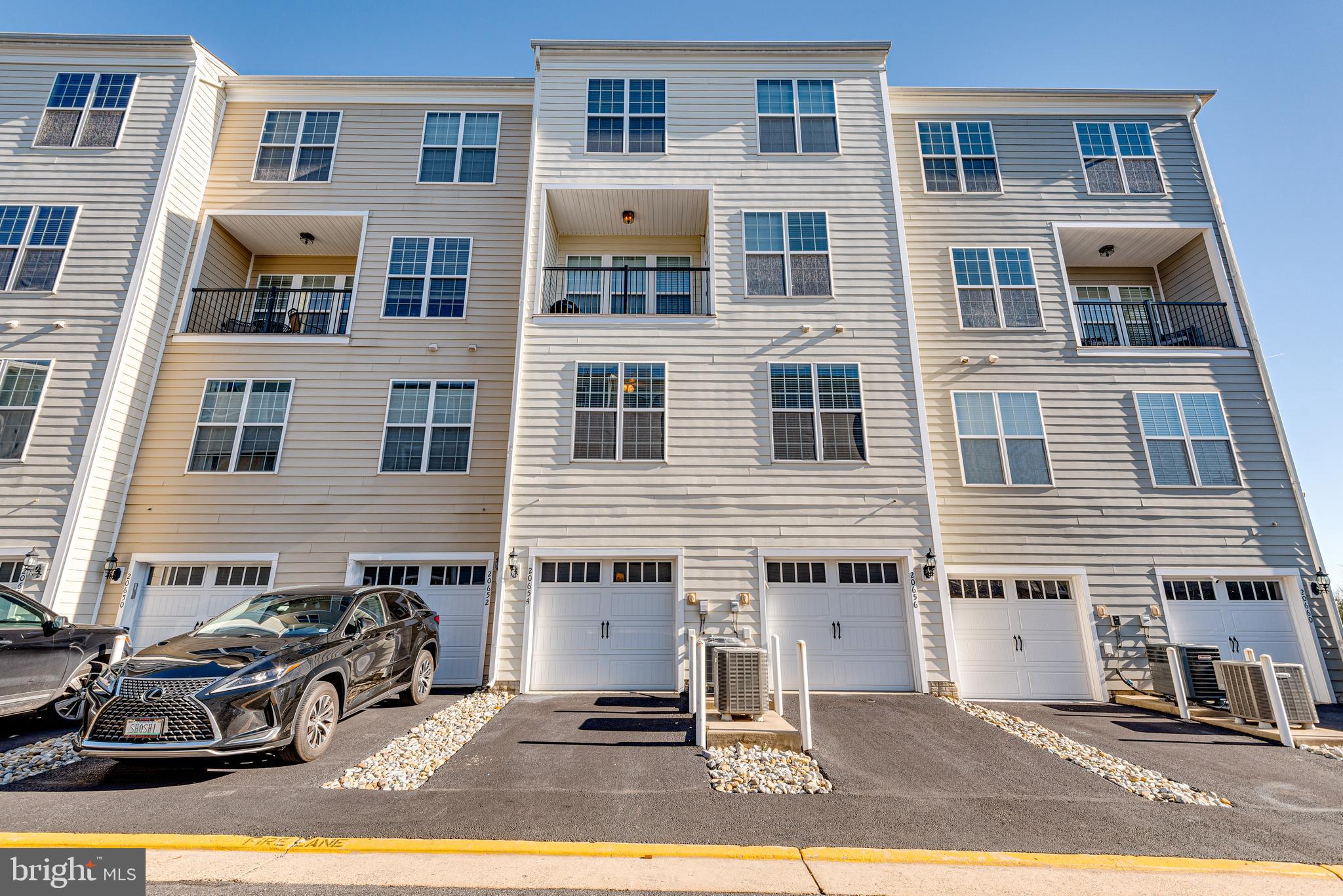 20654 Sibbald Square Ashburn, VA 20147 - Photo 40 of 43 a front view of a building with parking space