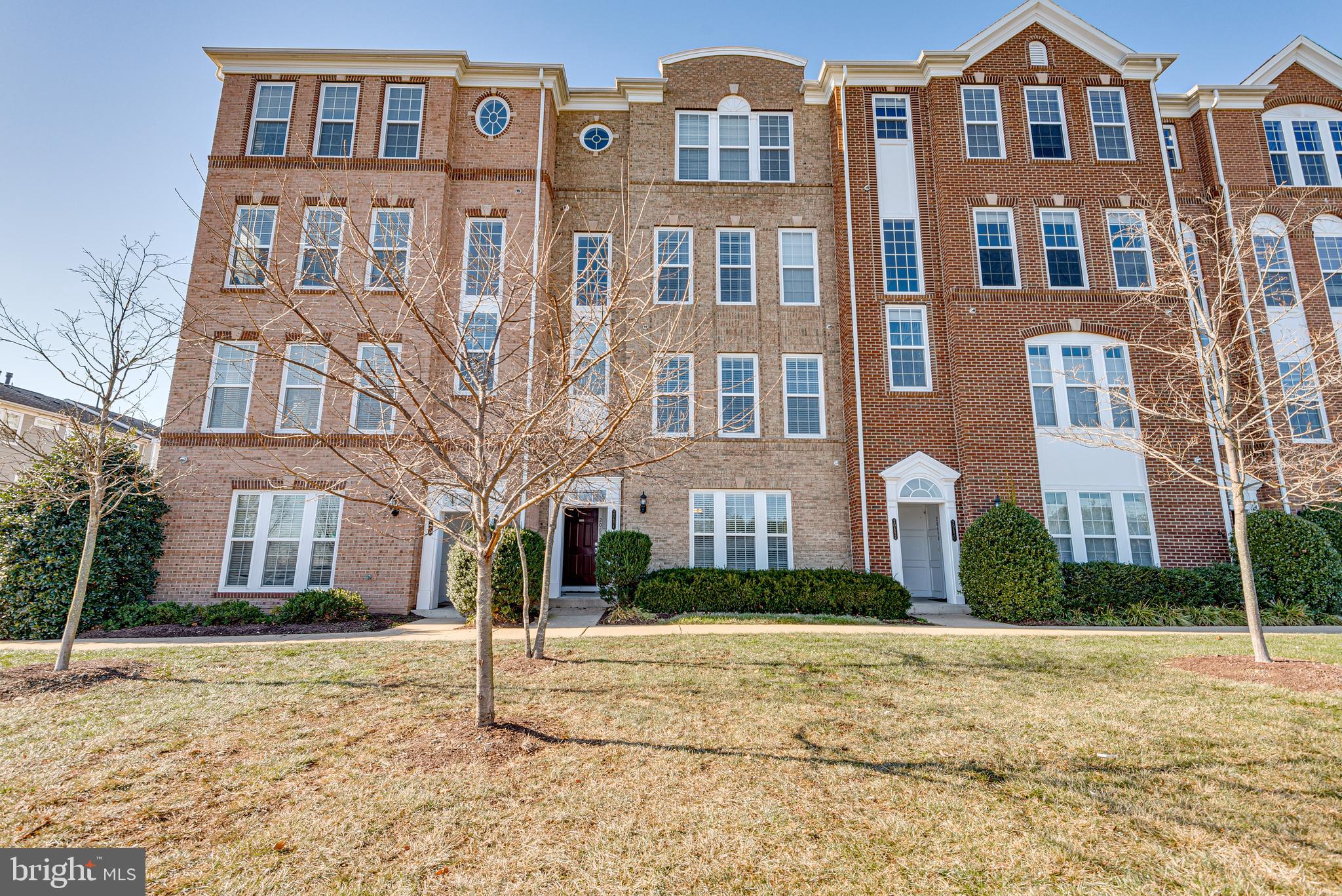 20654 Sibbald Square Ashburn, VA 20147 - Photo 4 of 43 a front view of a residential apartment building with a yard