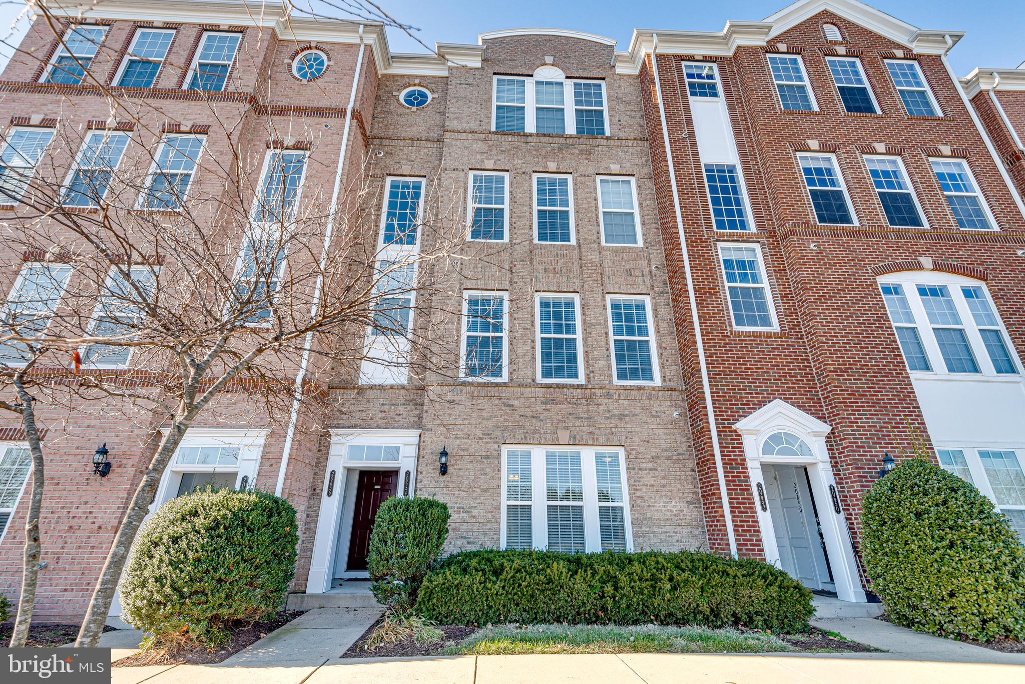 20654 Sibbald Square Ashburn, VA 20147 - Photo 6 of 43 a front view of a multi story residential apartment building
