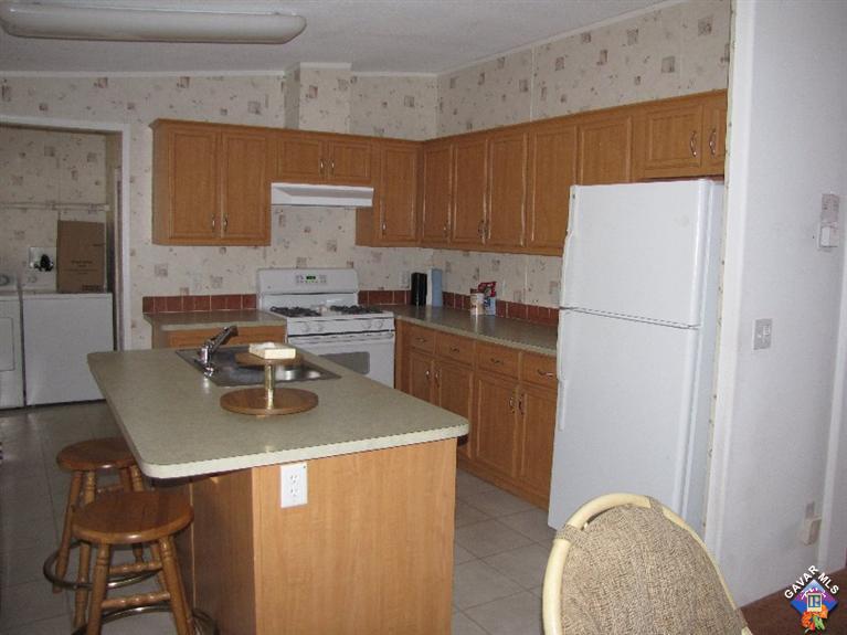 600 Dennison Road, Unit 53 Tehachapi, CA 93561 - Photo 12 of 25 a kitchen with a appliances a stove a refrigerator a sink and a stove