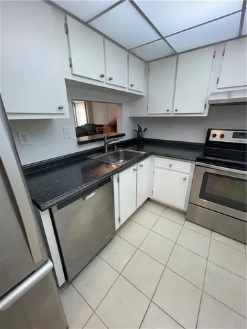 a kitchen with cabinets and appliances