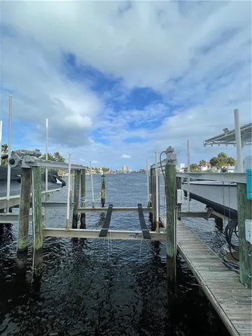 a living room with patio furniture and a large window
