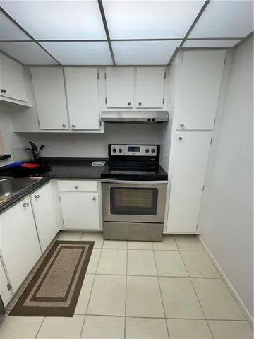 a kitchen with cabinets and appliances