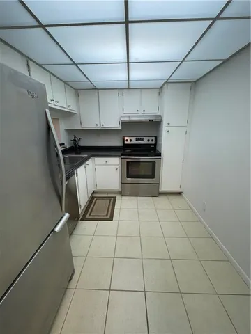 a kitchen with stainless steel appliances cabinets and a stove top oven