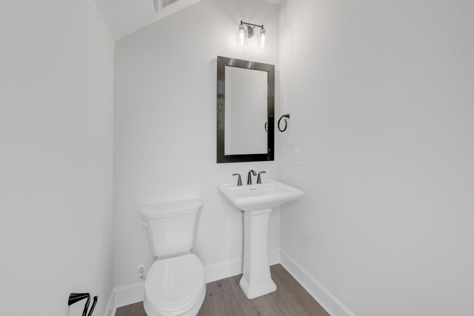 18019 Lobos Point Lane Conroe, TX 77302 - Photo 16 of 49 a bathroom with a toilet sink and mirror