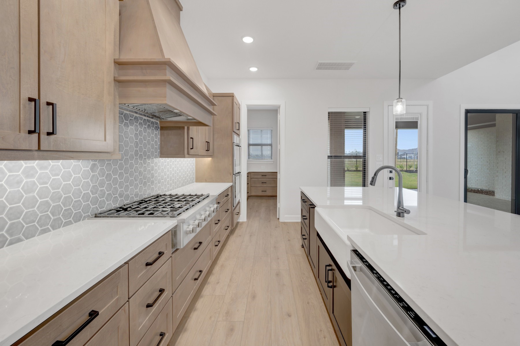 18019 Lobos Point Lane Conroe, TX 77302 - Photo 18 of 49 a kitchen with sink stove and cabinets