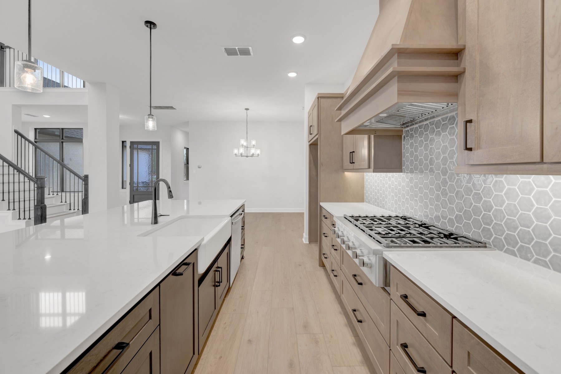18019 Lobos Point Lane Conroe, TX 77302 - Photo 19 of 49 a kitchen with kitchen island a counter top space a sink a stove and refrigerator