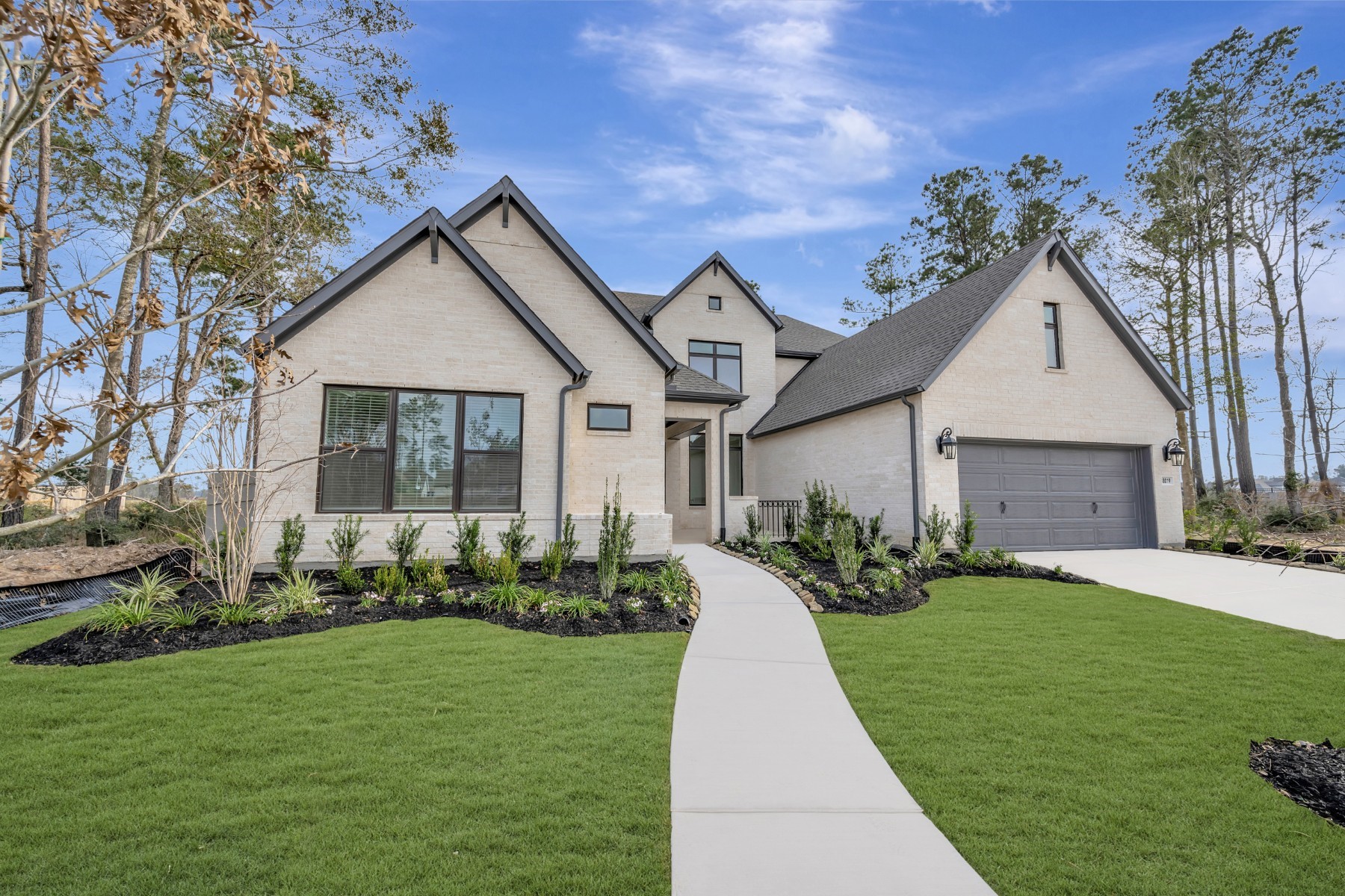 18019 Lobos Point Lane Conroe, TX 77302 - Photo 2 of 49 a front view of a house with a yard and porch