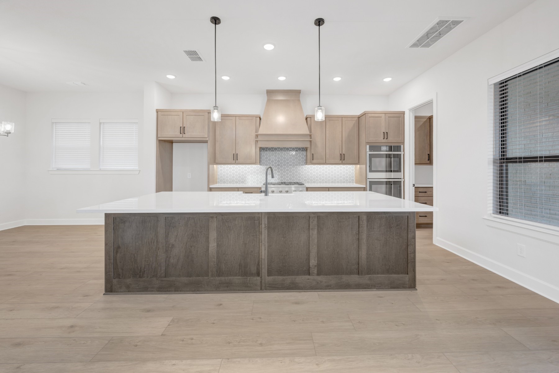 18019 Lobos Point Lane Conroe, TX 77302 - Photo 22 of 49 a large kitchen with a large counter top a sink stainless steel appliances and cabinets