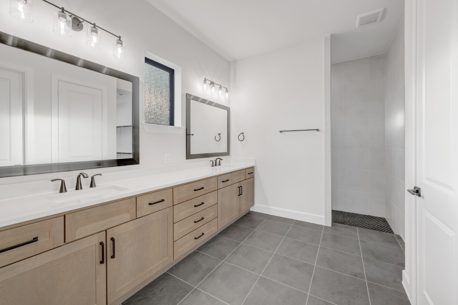 18019 Lobos Point Lane Conroe, TX 77302 - Photo 32 of 49 a spacious bathroom with 2 sink and a mirror