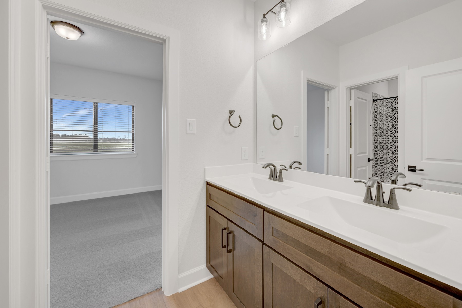 18019 Lobos Point Lane Conroe, TX 77302 - Photo 40 of 49 a bathroom with a sink double vanity and a mirror
