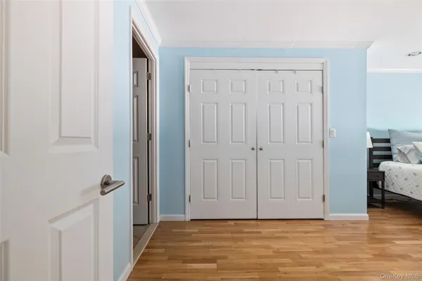 a view of a livingroom with wooden floor and closet