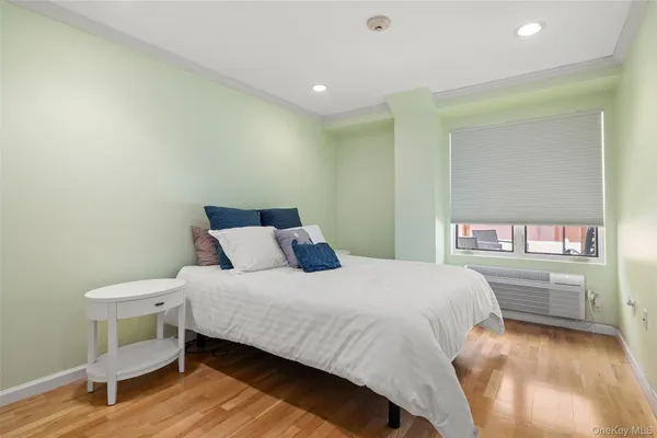 a bedroom with a bed and a large window