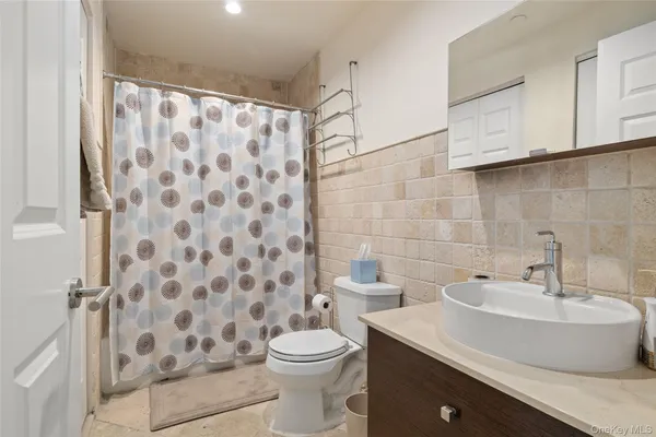 a bathroom with a sink toilet and shower